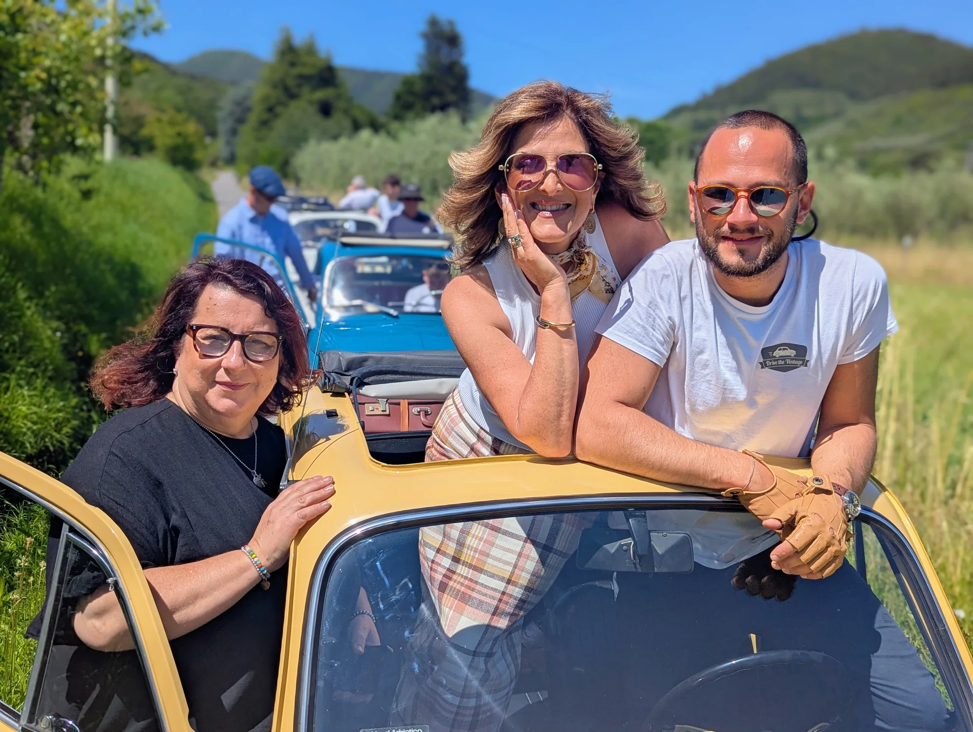 Travellers with vintage Fiat 500s in the poppies